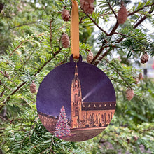 Load image into Gallery viewer, These beautiful Notre Dame Ornaments highlight Christmas Tree scenes from Notre Dame. The ornaments are 3 1/4" in diameter and feature beautiful full color stylized photos, imprinted on birch wood.