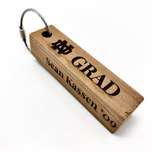 Load image into Gallery viewer, Our Notre Dame Grad Stadium Bench Wood Keychain measures 3.25" x .75" x .75".