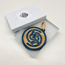 Load image into Gallery viewer, This Welsh Family Hall Christmas Ornament is made from blue-stained birch, laser-engraved, and is 3.25" in diameter.
