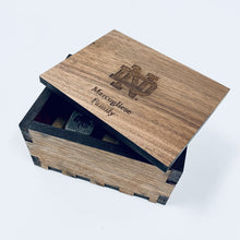 Load image into Gallery viewer, The engraved Notre Dame Whiskey Stones are presented in a laser-cut, handmade box, crafted from walnut wood and engraved with the ND Monogram. The stones are .75" square and the box measures 4" x 3" x 2.25".