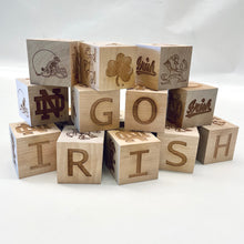 Load image into Gallery viewer, Each 2" x 2" block in this 16-block set is engraved on all 6 sides. Your child can spell NOTRE DAME and GO IRISH as well as enjoy the ND Monogram, Shamrock, Irish, Leprechaun, and an Irish football helmet!
