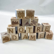 Load image into Gallery viewer, Each 2" x 2" block in this 16-block set is engraved on all 6 sides. Your child can spell NOTRE DAME and GO IRISH as well as enjoy the ND Monogram, Shamrock, Irish, Leprechaun, and an Irish football helmet!