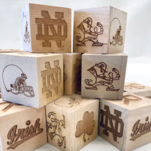 Load image into Gallery viewer, Each 2" x 2" block in this 16-block set is engraved on all 6 sides. Your child can spell NOTRE DAME and GO IRISH as well as enjoy the ND Monogram, Shamrock, Irish, Leprechaun, and an Irish football helmet!