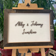 Load image into Gallery viewer, This custom Bride and Groom Sign with Stadium Wood Frame measures 19" x 14" and will be crafted from white-stained birch, natural walnut, and Notre Dame Stadium Bench wood!