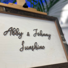 Load image into Gallery viewer, This custom Bride and Groom Sign with Stadium Wood Frame measures 19" x 14" and will be crafted from white-stained birch, natural walnut, and Notre Dame Stadium Bench wood!