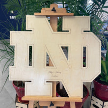 Load image into Gallery viewer, This beautiful Notre Dame Monogram Guest "Book" is crafted from golden, UV-prefinished 1/2" plywood and features a lasered pin-stripe outline. Our Notre Dame Monogram Guest "Book" measures 30" x 30".