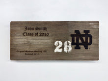 Load image into Gallery viewer, Notre Dame Stadium Bench Plaques are engraved with your chosen name, class year (or year became a fan) and the Notre Dame monogram. The 16" x 7 1/2" plaque is also engraved with the following text: "Original Stadium Seating 1930 Removed 2016".