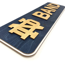 Load image into Gallery viewer, Show your ND Band spirit with this triple-layered sign! Our Premium ND Band Wall Sign measures 30.5" X 9" X .5" and includes hanging hardware.