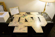 Load image into Gallery viewer, This beautiful Notre Dame Monogram Guest "Book" is crafted from golden, UV-prefinished 1/2" plywood and features a lasered pin-stripe outline. Our Notre Dame Monogram Guest "Book" measures 30" x 30".