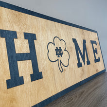 Load image into Gallery viewer, Our 24&quot; x 9&quot; x 1/2&quot; Premium Notre Dame HOME Horizontal Sign comes in two color ways: Gold on Blue
