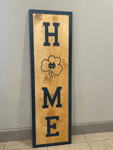 Our 40" x 12" x 1/2" Premium Notre Dame HOME Vertical Sign comes in two color ways: Gold on Blue