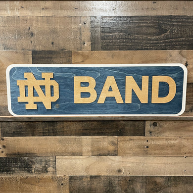 Wooden sign with 'ND Band' on a wooden background