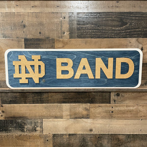 Wooden sign with 'ND Band' on a wooden background
