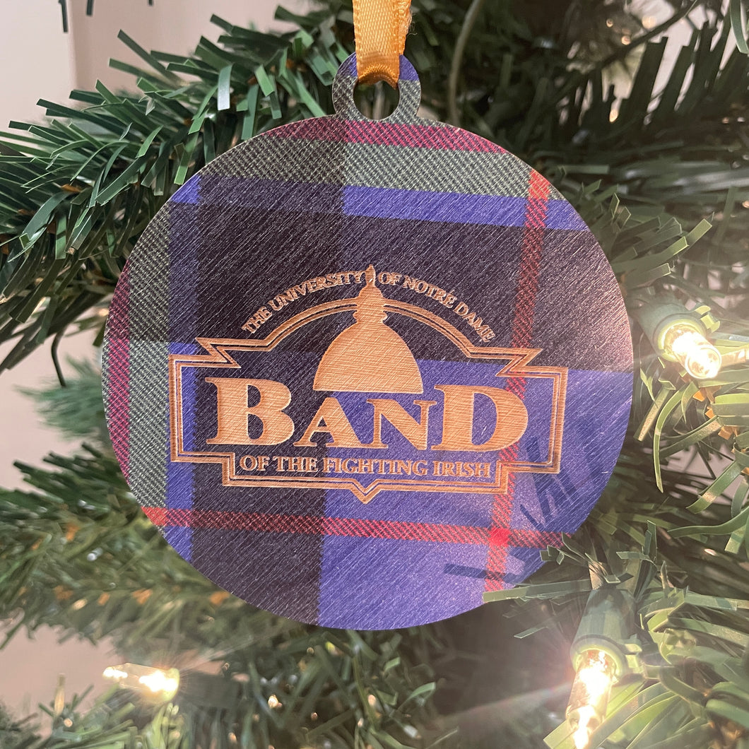 Plaid ornament with 'Band of the Fighting Irish' text on a Christmas tree.