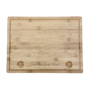 Our Love Thee Notre Dame Cutting Board is engraved with the Notre Dame Monogram Shamrock. It is made from bamboo and measures 15.75" x 11.75" x .75".