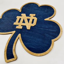 Load image into Gallery viewer, This Premium Notre Dame Monogram on Blue Shamrock Wall Art is currently available in three sizes: Small (12"), Medium (18") and Large (30").
